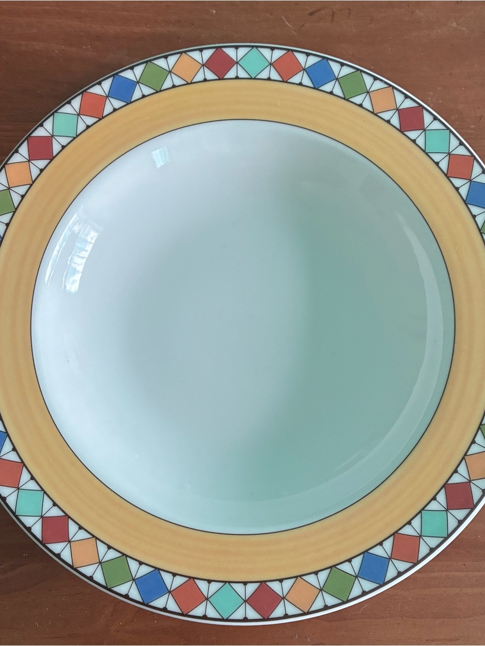 Villeroy and Boch pasta bowl 9”. Colorful triangles bordering a yellow stripe.